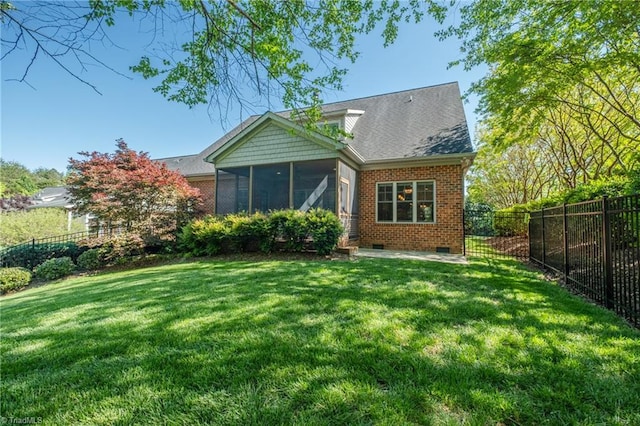 rear view of property with a lawn, a fenced backyard, a sunroom, and crawl space