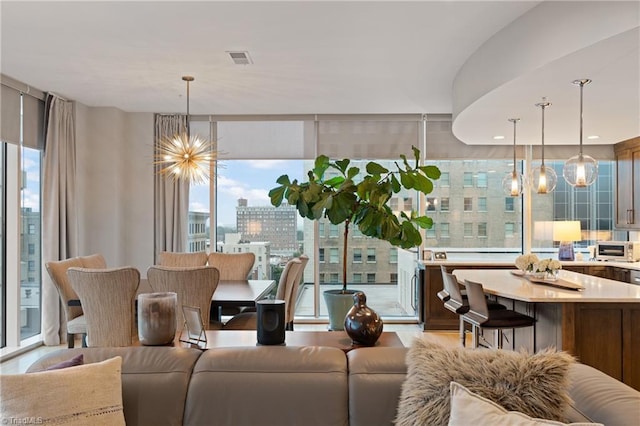 living room featuring expansive windows and an inviting chandelier