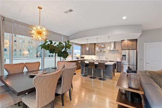 dining space featuring an inviting chandelier and light hardwood / wood-style floors