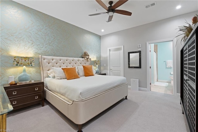 carpeted bedroom featuring connected bathroom and ceiling fan