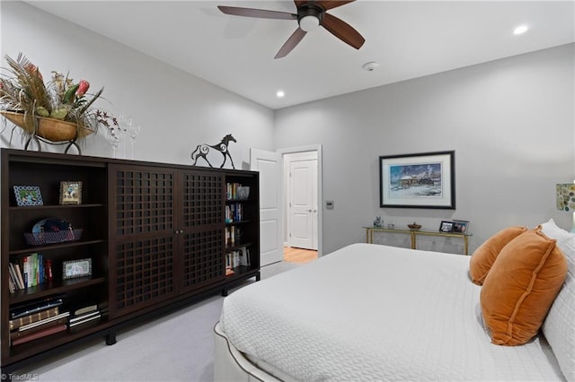 bedroom featuring light carpet and ceiling fan