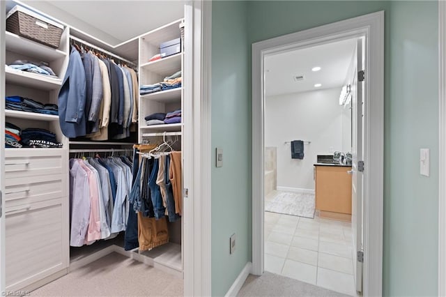 spacious closet featuring light tile patterned flooring