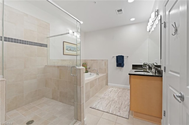 bathroom featuring vanity, plus walk in shower, and tile patterned floors