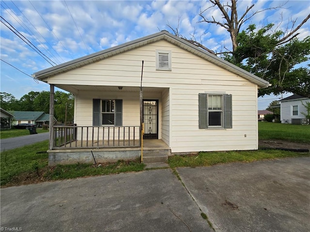 bungalow-style home featuring covered porch and central air condition unit