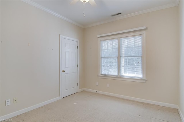 unfurnished room with ornamental molding, light colored carpet, and ceiling fan