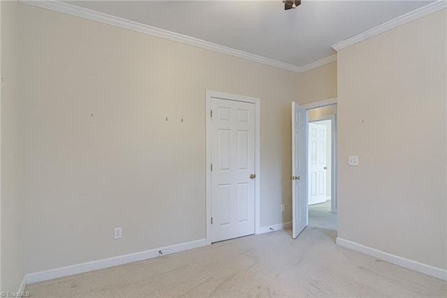 unfurnished room with ornamental molding and light carpet