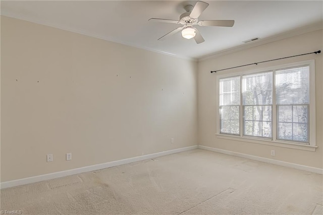 unfurnished room with crown molding, light colored carpet, and ceiling fan