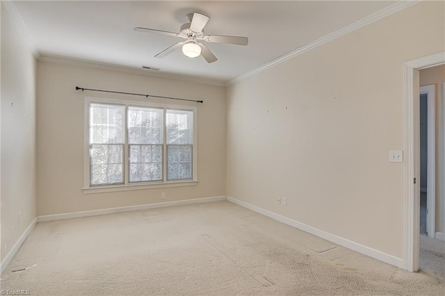 carpeted empty room with crown molding and ceiling fan