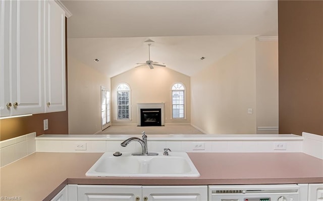 kitchen featuring lofted ceiling, sink, white cabinetry, dishwasher, and ceiling fan