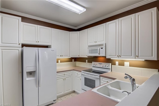 kitchen with sink, white cabinets, and white appliances