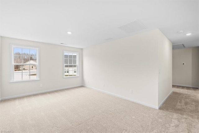 unfurnished room featuring light carpet