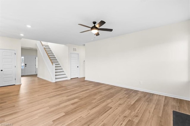 unfurnished living room featuring ceiling fan and light hardwood / wood-style flooring