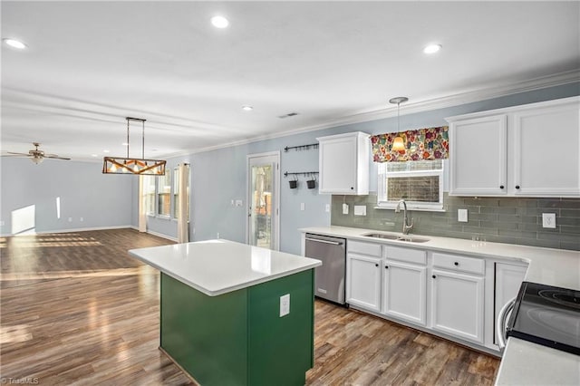 kitchen with hanging light fixtures, white cabinets, a kitchen island, sink, and stainless steel appliances