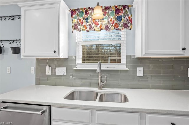 kitchen with dishwasher, sink, decorative light fixtures, backsplash, and white cabinetry