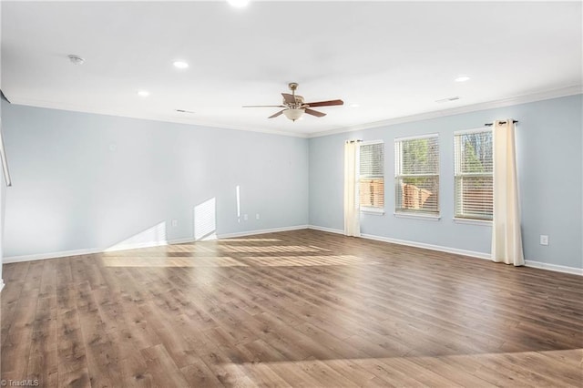 spare room featuring light wood-type flooring, ceiling fan, and ornamental molding