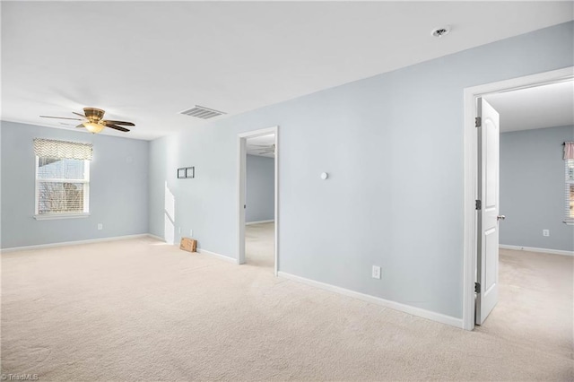 empty room with light colored carpet and ceiling fan