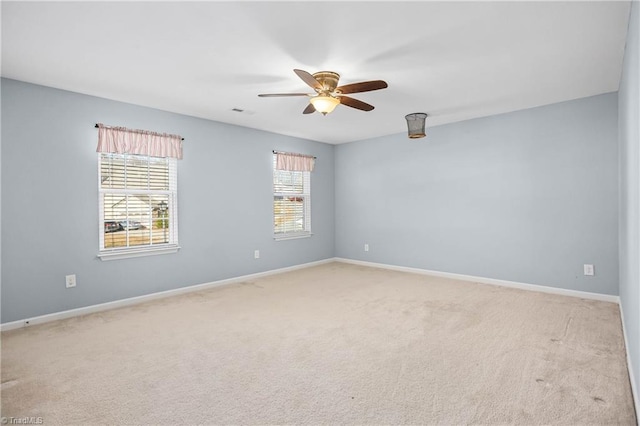 carpeted spare room with ceiling fan