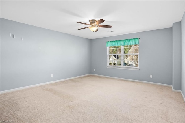 spare room featuring ceiling fan and carpet