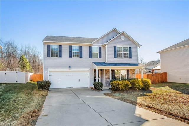 view of property with a garage, a front yard, and covered porch