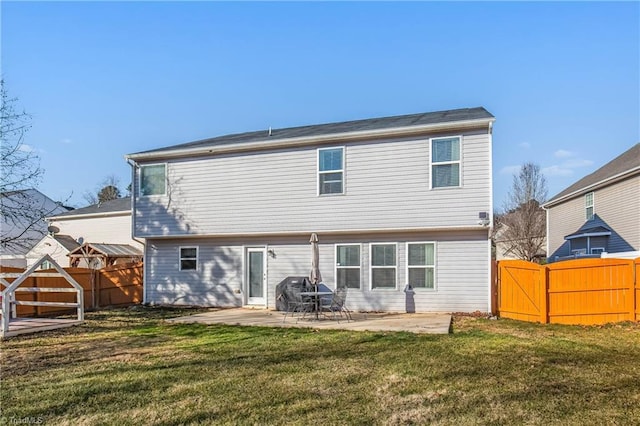 rear view of property with a patio and a lawn