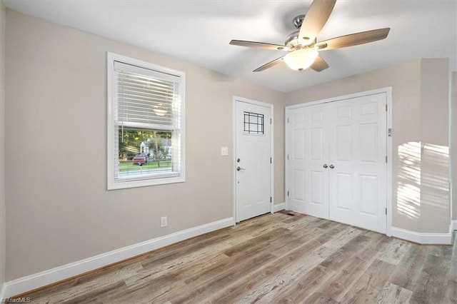 entrance foyer with ceiling fan and light wood-type flooring