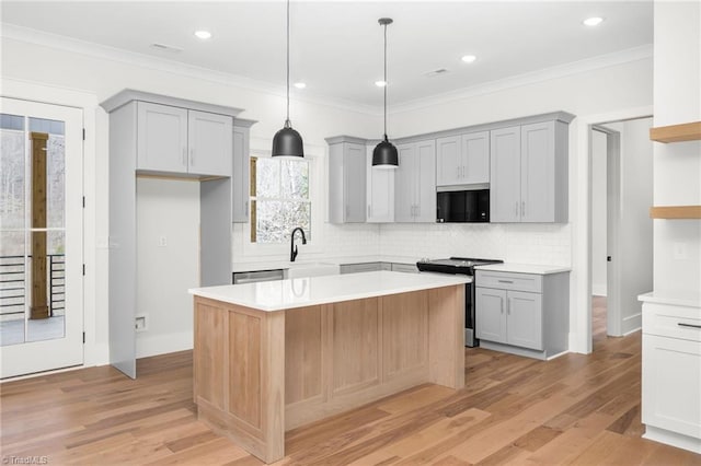 kitchen featuring a sink, stainless steel appliances, light wood-type flooring, and gray cabinets