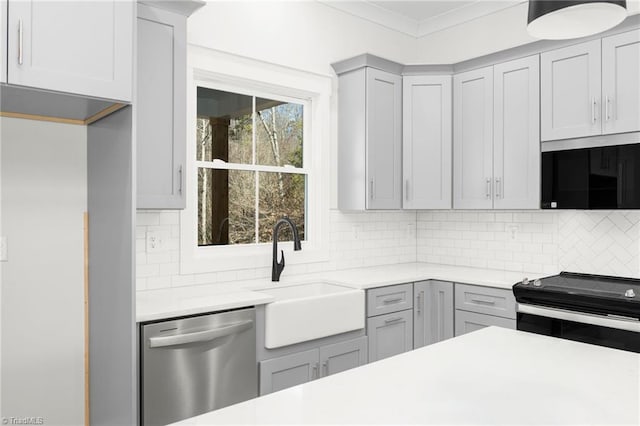 kitchen featuring a sink, gray cabinets, dishwasher, and light countertops