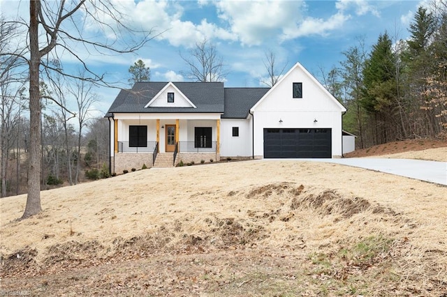 modern farmhouse style home featuring a porch, a shingled roof, and a garage