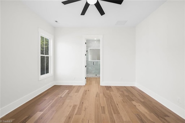 empty room featuring light wood-type flooring, ceiling fan, and baseboards