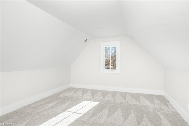 bonus room featuring carpet, baseboards, and vaulted ceiling