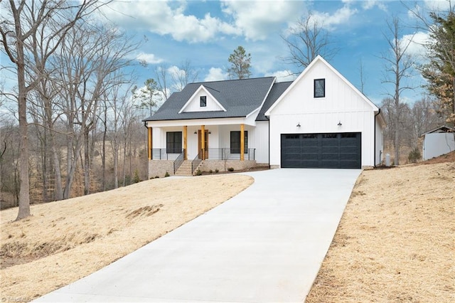 modern farmhouse style home with a porch, board and batten siding, and concrete driveway