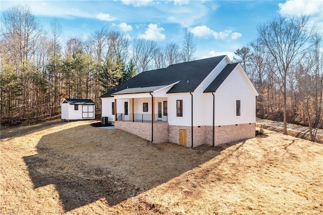 view of front of house featuring an outbuilding, a shed, and cooling unit