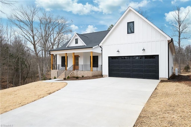 modern farmhouse with board and batten siding, covered porch, and concrete driveway