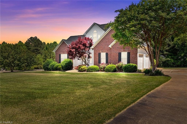 view of front of home featuring a garage and a yard