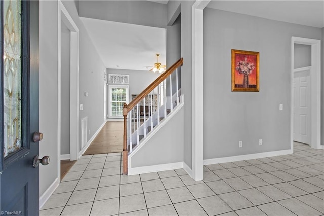 entryway featuring ceiling fan and light tile patterned floors