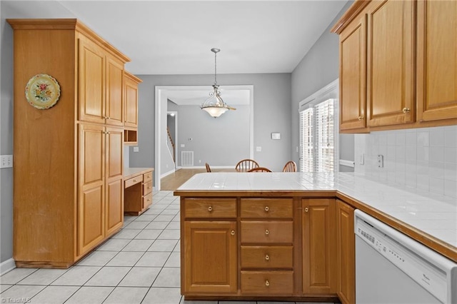 kitchen featuring kitchen peninsula, backsplash, decorative light fixtures, dishwasher, and light tile patterned flooring