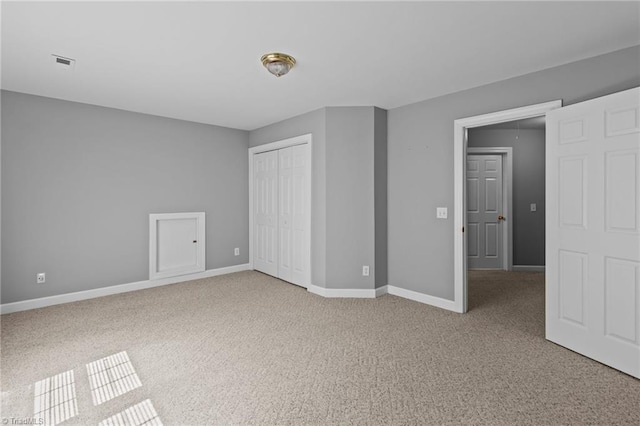 unfurnished bedroom featuring carpet floors and a closet