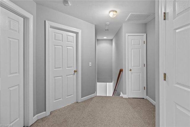 corridor featuring light colored carpet