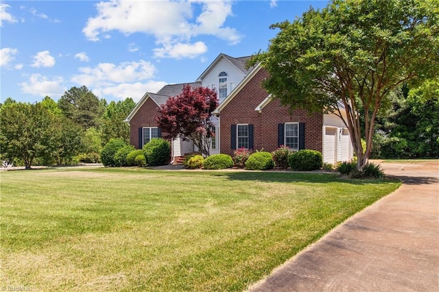 view of front facade with a garage and a front lawn