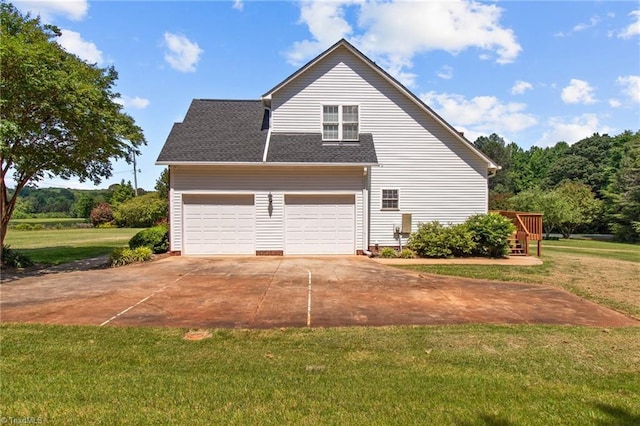 view of property exterior featuring a yard and a garage