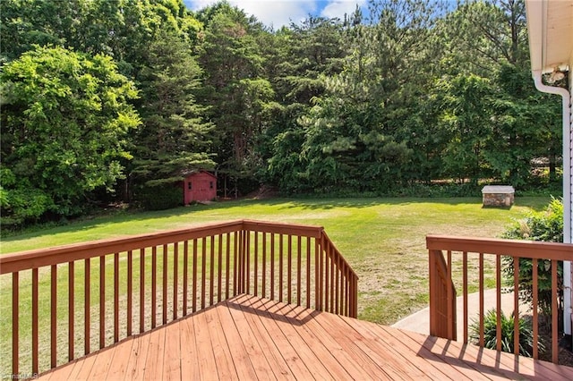 deck with a yard and a shed