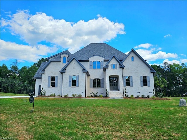 french country inspired facade featuring a front lawn