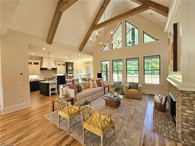 living room featuring a chandelier, hardwood / wood-style flooring, high vaulted ceiling, and beamed ceiling