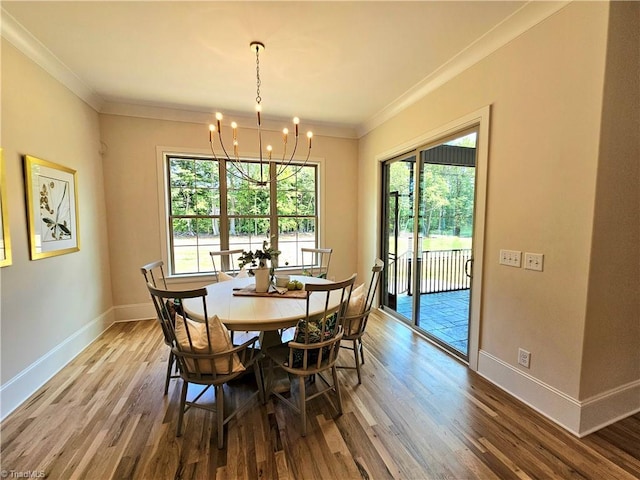 dining room featuring a wealth of natural light, crown molding, and wood-type flooring