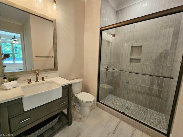 bathroom featuring toilet, an enclosed shower, crown molding, and vanity