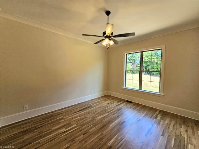 unfurnished room with crown molding, ceiling fan, and dark wood-type flooring