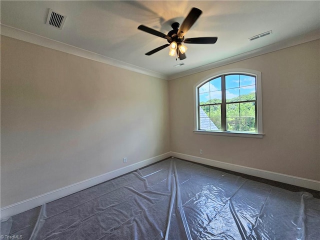 spare room featuring ceiling fan and crown molding