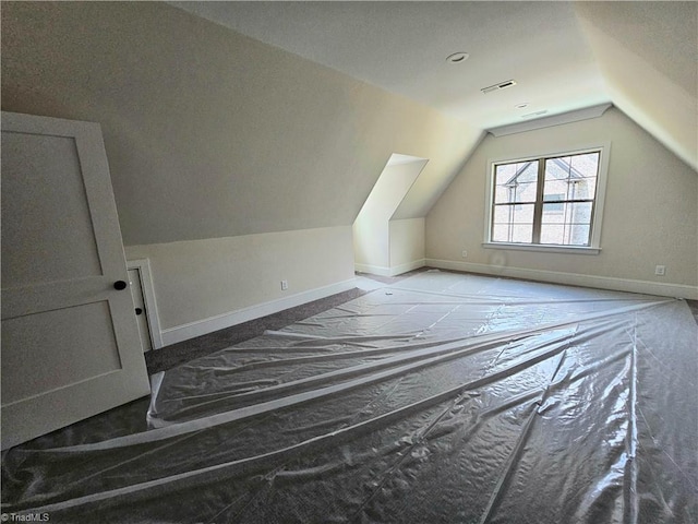 bonus room with a textured ceiling and vaulted ceiling