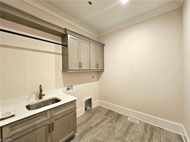 laundry room with electric dryer hookup, cabinets, sink, washer hookup, and dark hardwood / wood-style floors