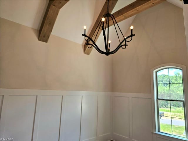 details featuring beamed ceiling and a chandelier